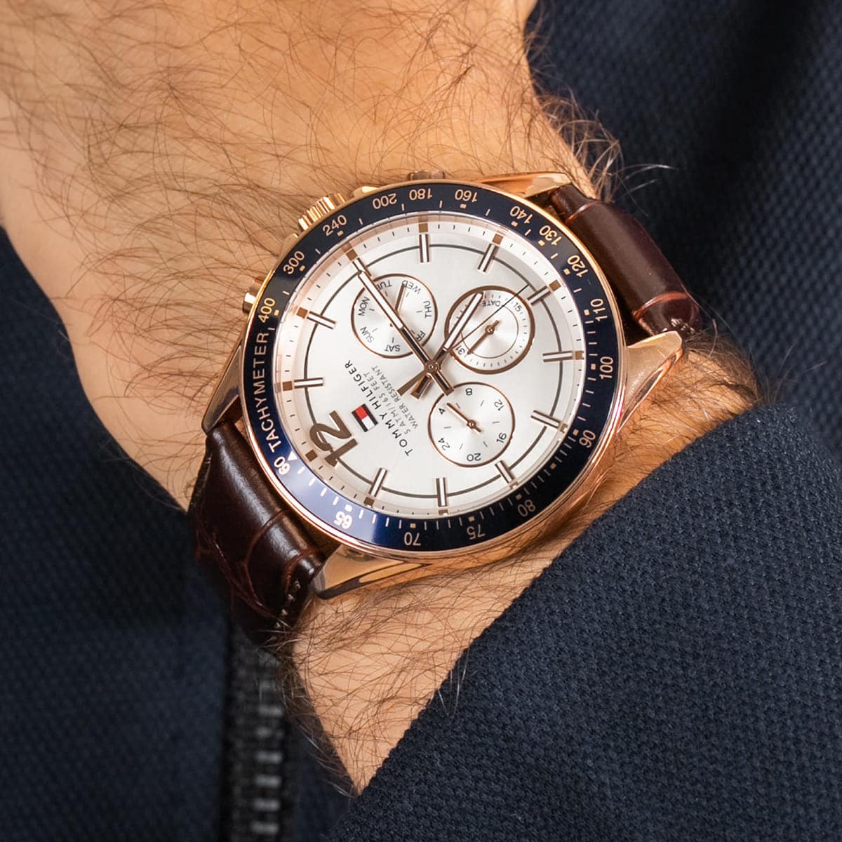 TOMMY HILFIGER 1791118 Luke Multifunction Men's Watch with rose gold-tone case, white dial, and brown leather strap.